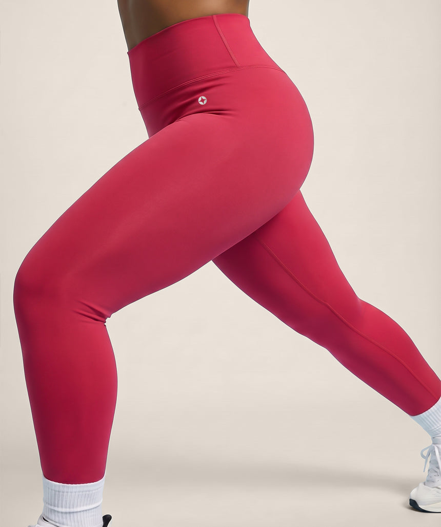 Raspberry Red leggings worn by a person on a beige background