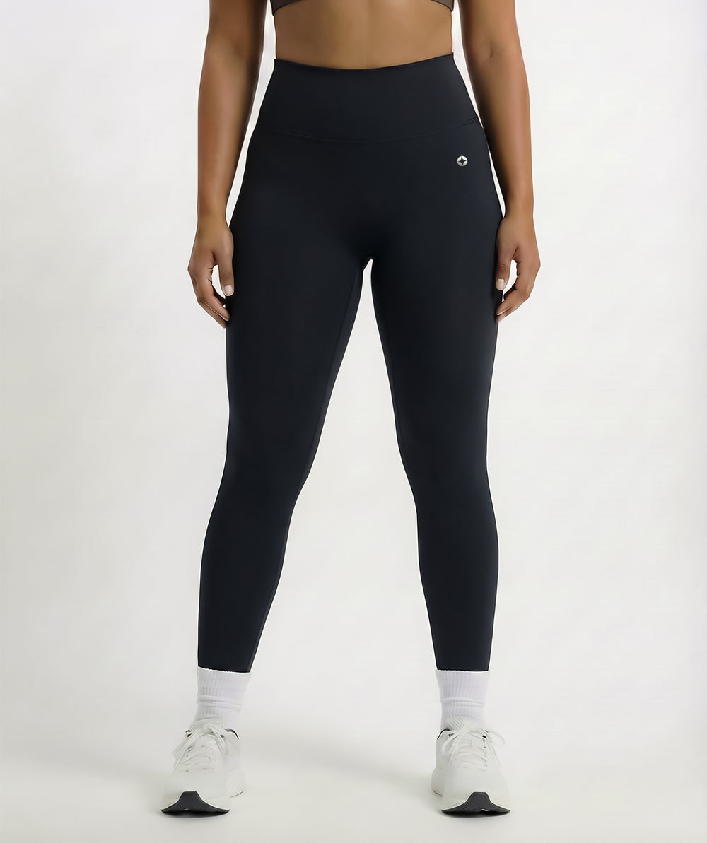 Person wearing black leggings on a white background